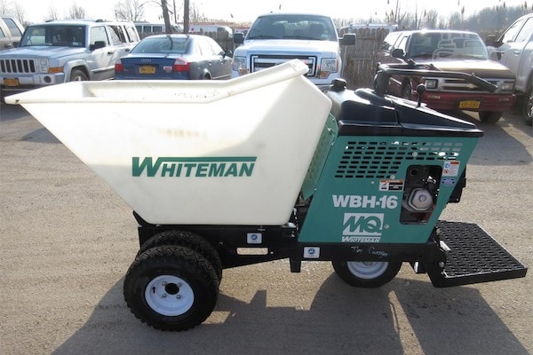 White Whiteman WBH-16 concrete mixer on a parking lot surrounded by other cars.